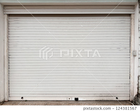 Closed white metal garage door with dirt stains Closed white metal garage door with dirt stains 124381567