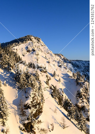 The snowy landscape of the Kuroboyama mountain ridge dyed in the morning glow The snowy landscape of the Kuroboyama mountain ridge dyed in the morning glow 124381762