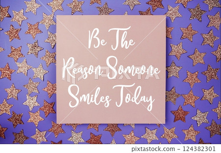 Be The Reason Someone Smiles Today text motivational and inspiration quote on paper card with star glitter decoration flat lay on purple background Be The Reason Someone Smiles Today text motivational and inspiration quote on paper card with star glitter decoration flat lay on purple background 124382301