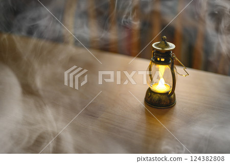 A table with a small lamp A table with a small lamp 124382808