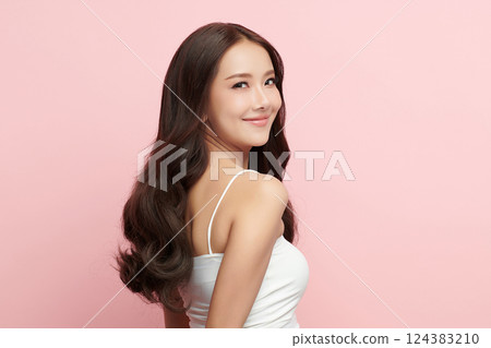 A beautiful young Asian woman with clean, fresh skin against a pink background. Skincare, facial treatment, cosmetology, beauty, and spa. An elegant portrait of an Asian woman. A beautiful young Asian woman with clean, fresh skin against a pink background. Skincare, facial treatment, cosmetology, beauty, and spa. An elegant portrait of an Asian woman. 124383210