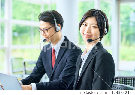 Businessman working in a call center Businessman working in a call center 124384213
