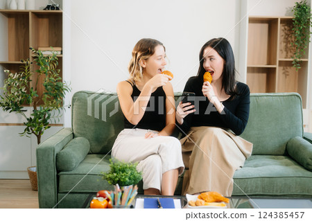 Explore vibrant teamwork, creativity, and learning with young adults using laptops and headphones in cozy 124385457