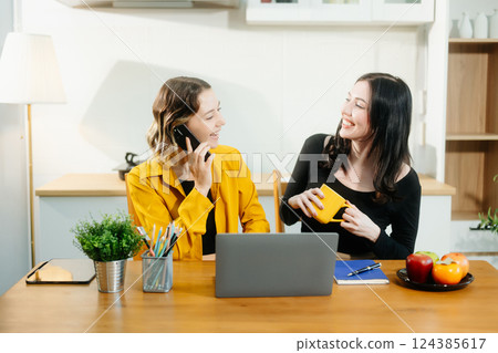 Caucasian  Teamwork and creativity with sitting working at kitchen table young collaborating 124385617