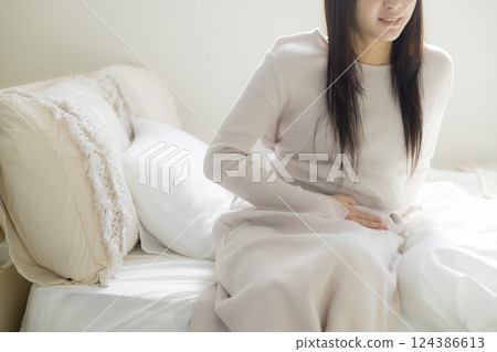 Unwell woman in bed Unwell woman in bed 124386613