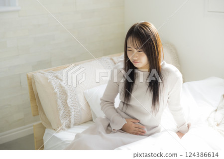 Unwell woman in bed 124386614