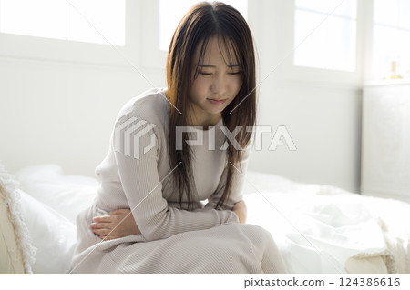 Unwell woman in bed Unwell woman in bed 124386616