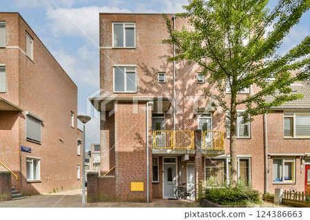 Contemporary residential buildings with distinctive architectural features and well-maintained greenery in the surroundings. 124386663