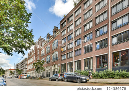 A picturesque street scene featuring modern buildings alongside traditional architecture, complemented by lush greenery and a clear sky. A picturesque street scene featuring modern buildings alongside traditional architecture, complemented by lush greenery and a clear sky. 124386676