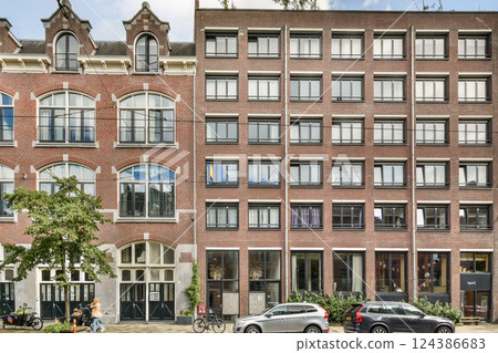 A striking contrast of modern and historic architectural styles showcases the beauty of urban design and diversity in building aesthetics. A striking contrast of modern and historic architectural styles showcases the beauty of urban design and diversity in building aesthetics. 124386683