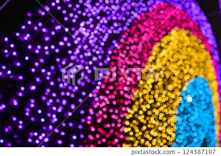 Colored decorative festive bokeh lights sparkle brightly. 124387107