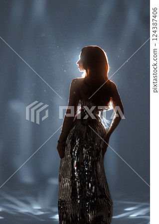 Glamorous Woman in Sparkling Light and Falling Glitter Glamorous Woman in Sparkling Light and Falling Glitter 124387406