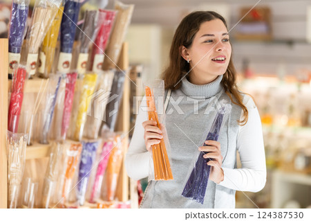 Girl client chooses aroma sticks, inhales fragrance Girl client chooses aroma sticks, inhales fragrance 124387530