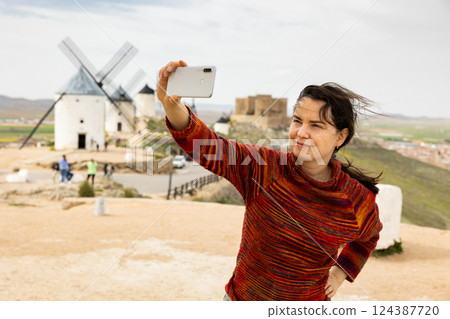 Female tourist taking selfies in Consuerga, Province of Toledo, Spain 124387720