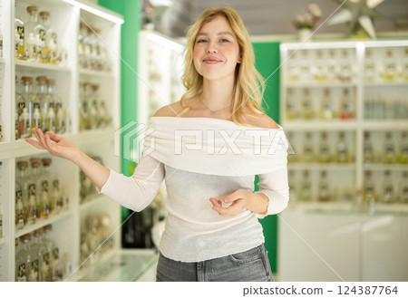 Nice girl, an employee of perfume shop, invites you to go shopping Nice girl, an employee of perfume shop, invites you to go shopping 124387764