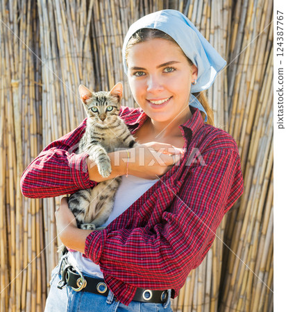Portrait of young woman with cat 124387767
