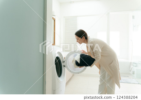 Woman doing the laundry Woman doing the laundry 124388204