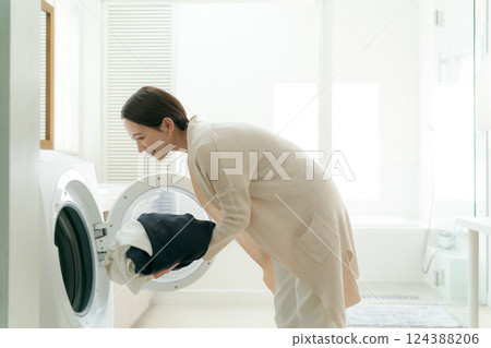 Woman doing the laundry 124388206