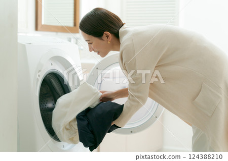 Woman doing the laundry 124388210