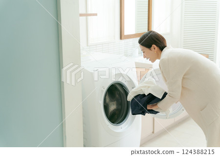 Woman doing the laundry 124388215