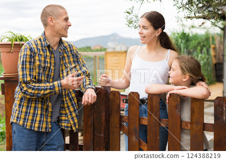 Farm neighbors talk at border in village 124388219