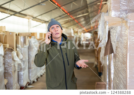 Storekeeper having telephone conversation during working day Storekeeper having telephone conversation during working day 124388288