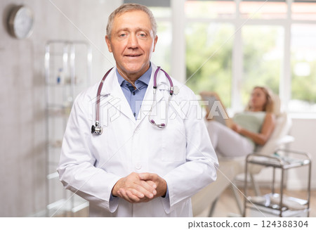 Mature male doctor represents services provided in medical clinic 124388304