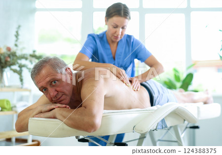 male patient having massage 124388375