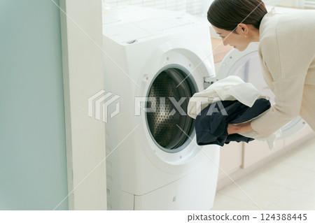 Woman doing the laundry Woman doing the laundry 124388445