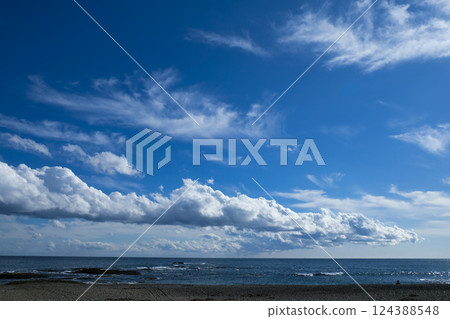 Clouds stretching out like tongues over the sea 124388548