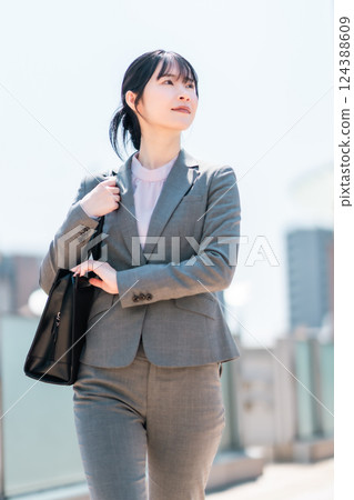 A refreshing businesswoman in a suit commuting to work A refreshing businesswoman in a suit commuting to work 124388609
