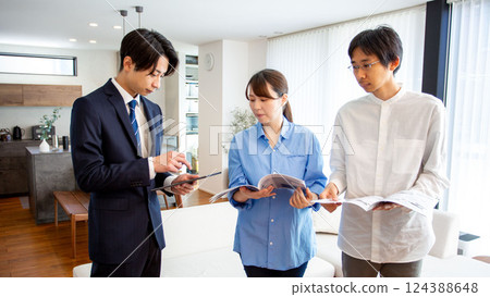 Housing sales: Japanese salesman showing a model room 124388648