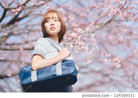 High school girl under the cherry blossoms High school girl under the cherry blossoms 124389331