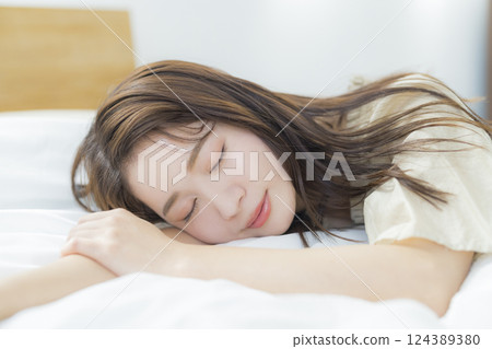 A woman lying on the bed A woman lying on the bed 124389380