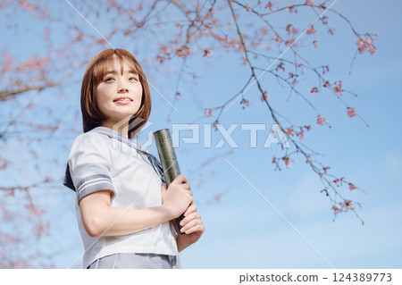 High school girl under the blue sky and cherry blossoms 124389773