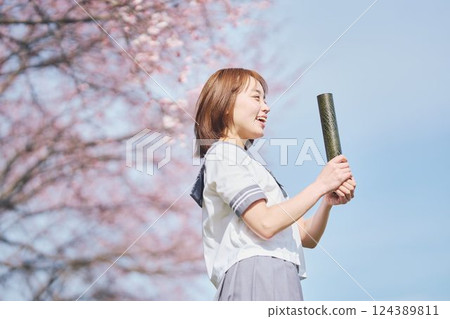 High school girl under the blue sky and cherry blossoms High school girl under the blue sky and cherry blossoms 124389811