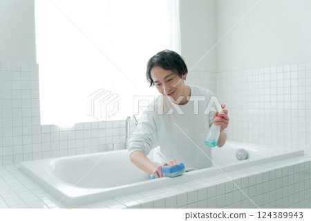 Men cleaning the bath Men cleaning the bath 124389943