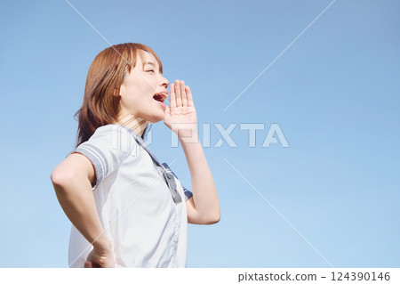 A high school girl calling out under the blue sky A high school girl calling out under the blue sky 124390146