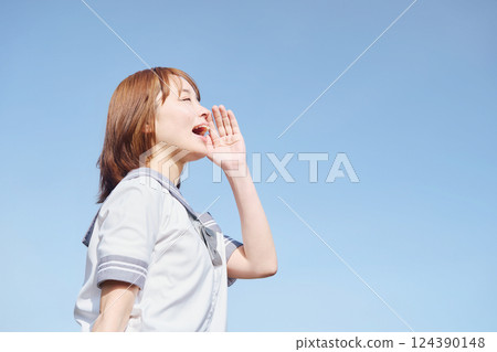 A high school girl calling out under the blue sky 124390148