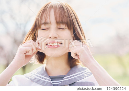 A high school girl with a funny expression A high school girl with a funny expression 124390224