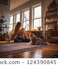 A cat relaxing next to a yoga enthusiast 124390845