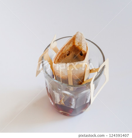 Paper drip or brewed bag of coffee on cup 124391407
