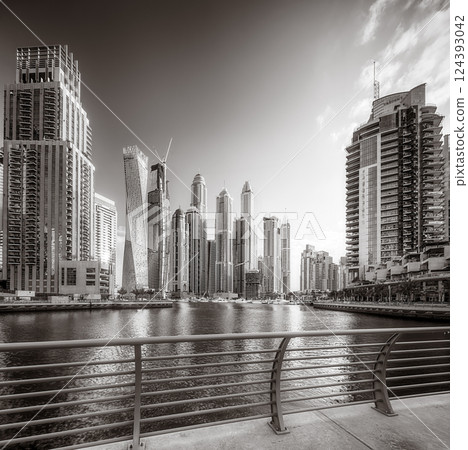 Skyscrapers and Urban city skyline over water, black and white style, city background, Dubai Marina bay UAE Skyscrapers and Urban city skyline over water, black and white style, city background, Dubai Marina bay UAE 124393042