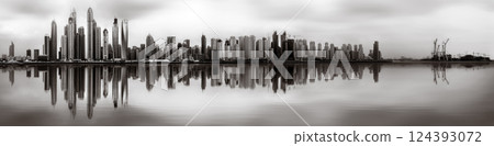 Skyscrapers and bridge over water, black and white style, city background, Dubai Marina bay UAE 124393072