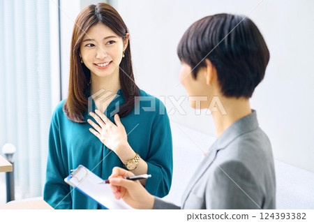 Two businesswomen having a meeting in an office. Photo courtesy of Sky Perfect Tokyo Media Center. 124393382