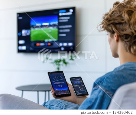 Multi-screen sports fanatic at home 124393462