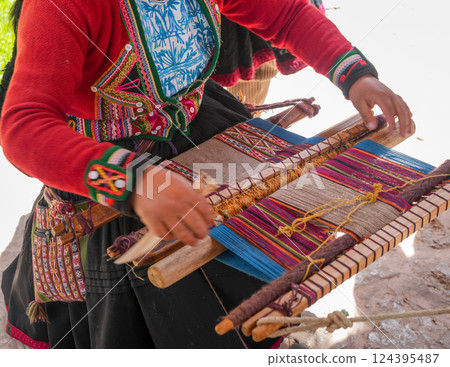 Andean artisan weaving a colorful textile near Cusco, Peru Andean artisan weaving a colorful textile near Cusco, Peru 124395487