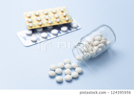 Pills on a blue background 124395956