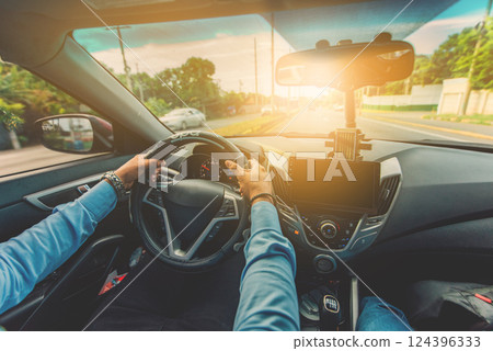 Close up of driver holding the steering wheel while driving at high speed Close up of driver holding the steering wheel while driving at high speed 124396333