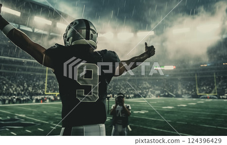american football or rugby player man celebrating goal and raising hand at stadium, championship and winning concept 124396429